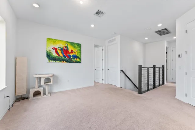 a view of an empty room with painting on the wall