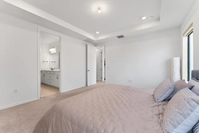 a view of a bedroom with a bed and bathroom
