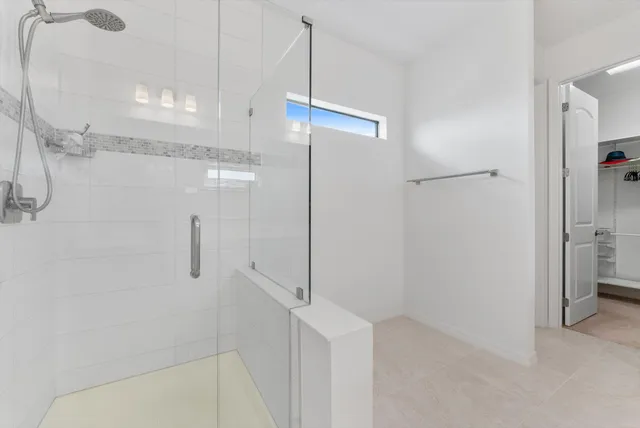 a bathroom with a shower and a glass door