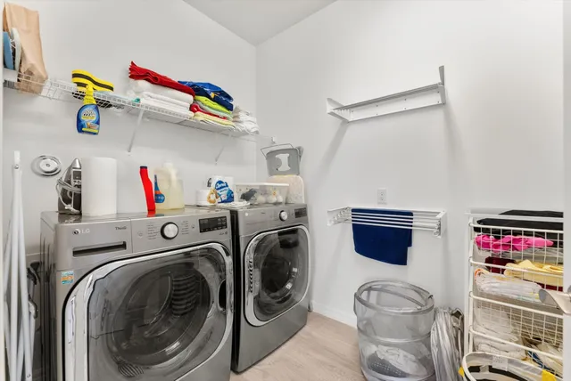a utility room with sink dryer and washer