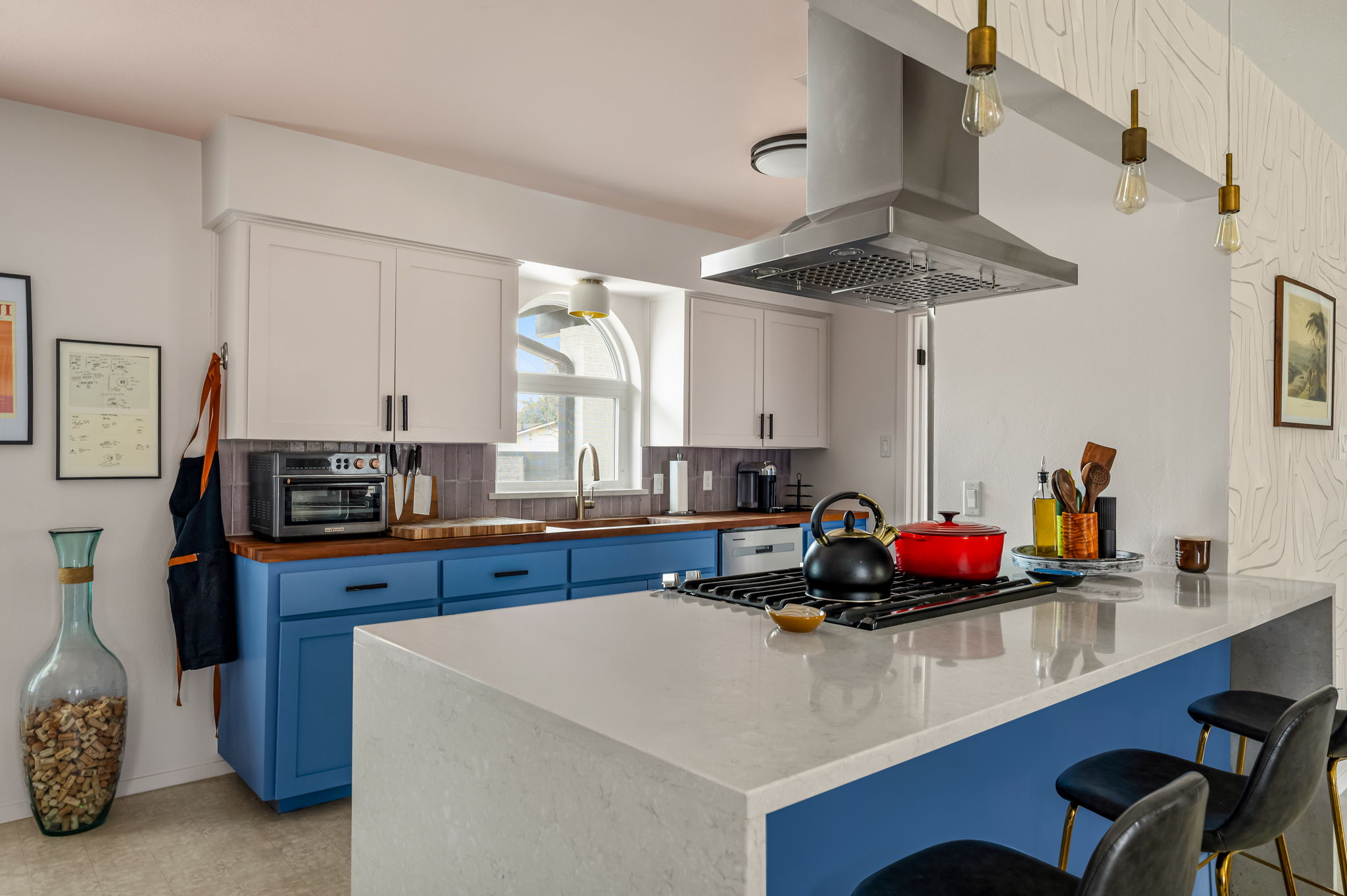 9300 Meadow Vale Austin, TX 78758 - Photo 15 of 37 Kitchen featuring a peninsula, a kitchen bar, island range hood, decorative backsplash, and dual tone cabinetry