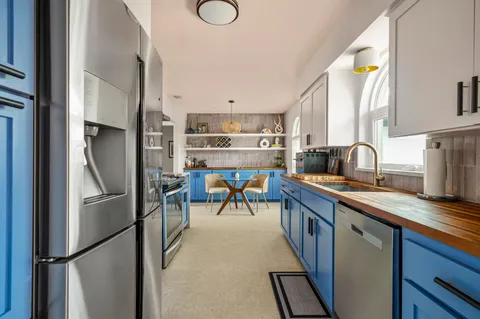 a kitchen with refrigerator and cabinets