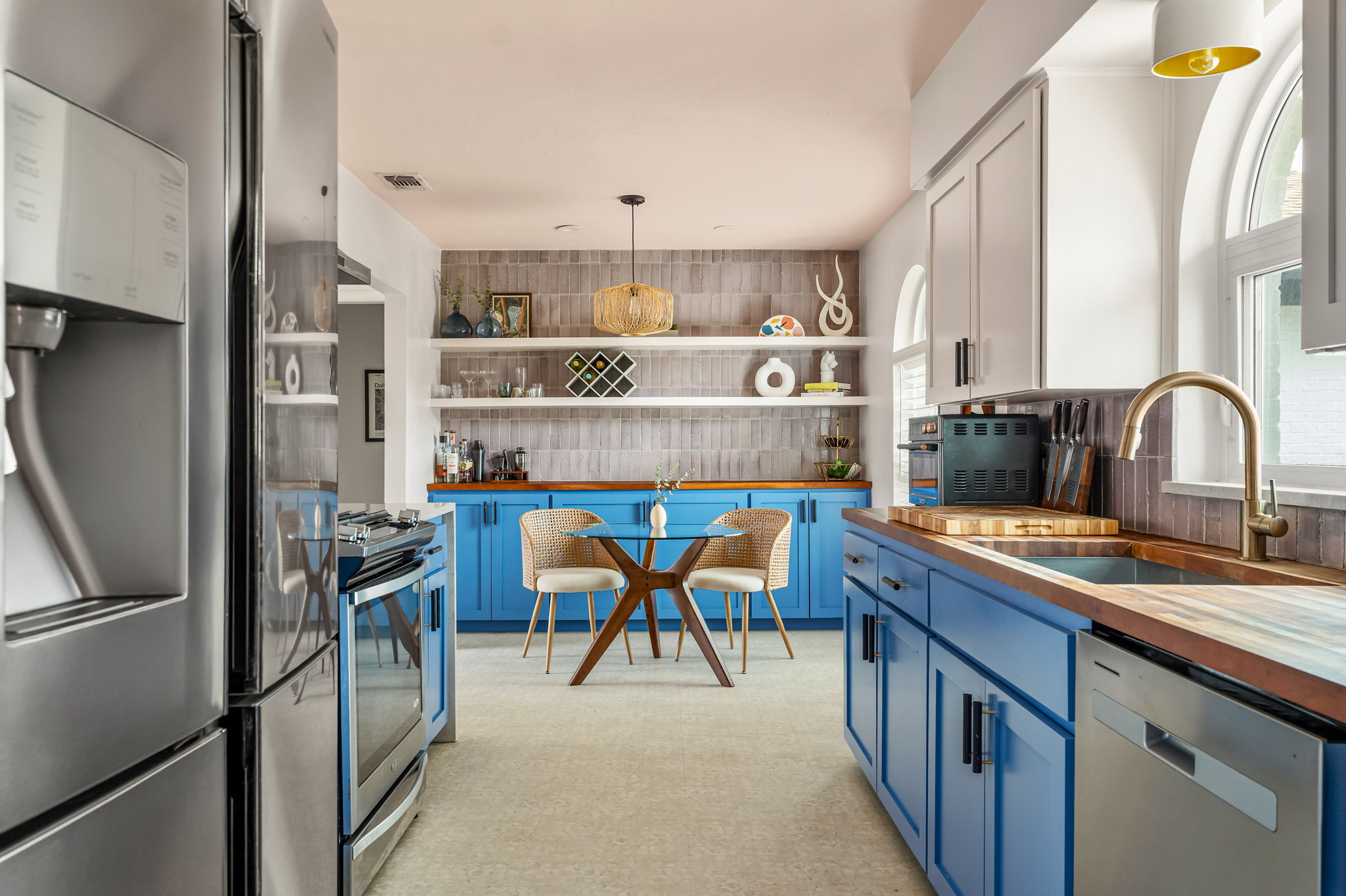 9300 Meadow Vale Austin, TX 78758 - Photo 18 of 37 Kitchen featuring stainless steel appliances, butcher block countertops, decorative light fixtures, open shelves, and two tone cabinetry