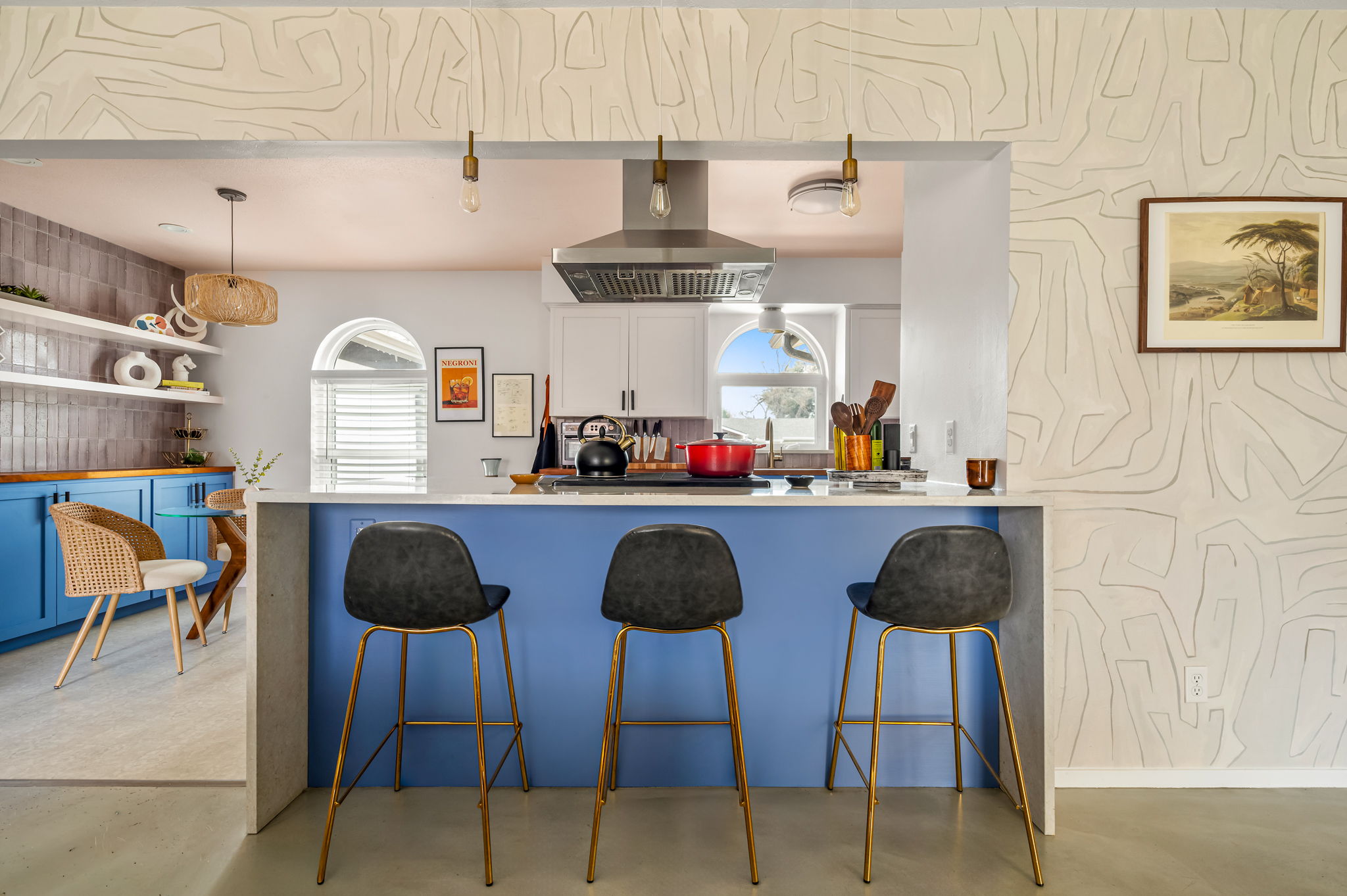 9300 Meadow Vale Austin, TX 78758 - Photo 21 of 37 Kitchen with a kitchen breakfast bar, a peninsula, white cabinetry, concrete floors, and decorative light fixtures
