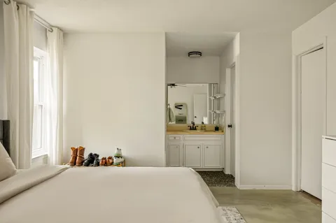 a room with a bed and a dresser