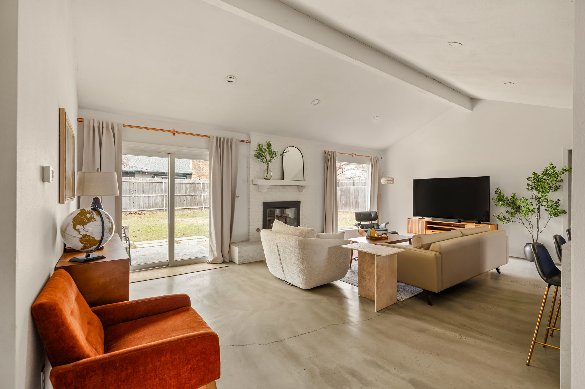 9300 Meadow Vale Austin, TX 78758 - Photo 3 of 37 Living room featuring finished concrete flooring, a glass covered fireplace, plenty of natural light, and beam ceiling