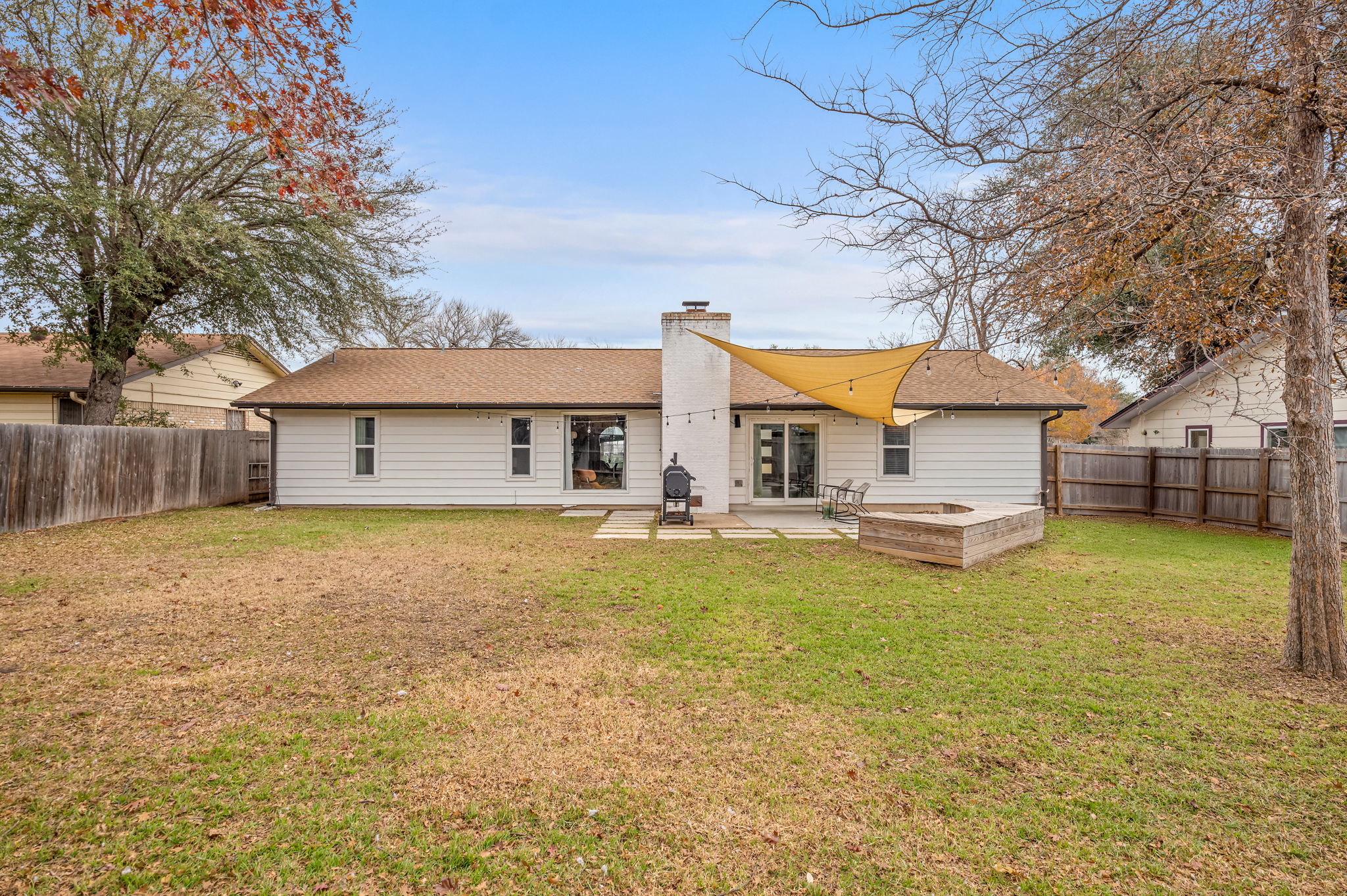 9300 Meadow Vale Austin, TX 78758 - Photo 34 of 37 Back of house with a patio area, a chimney, and a fenced backyard