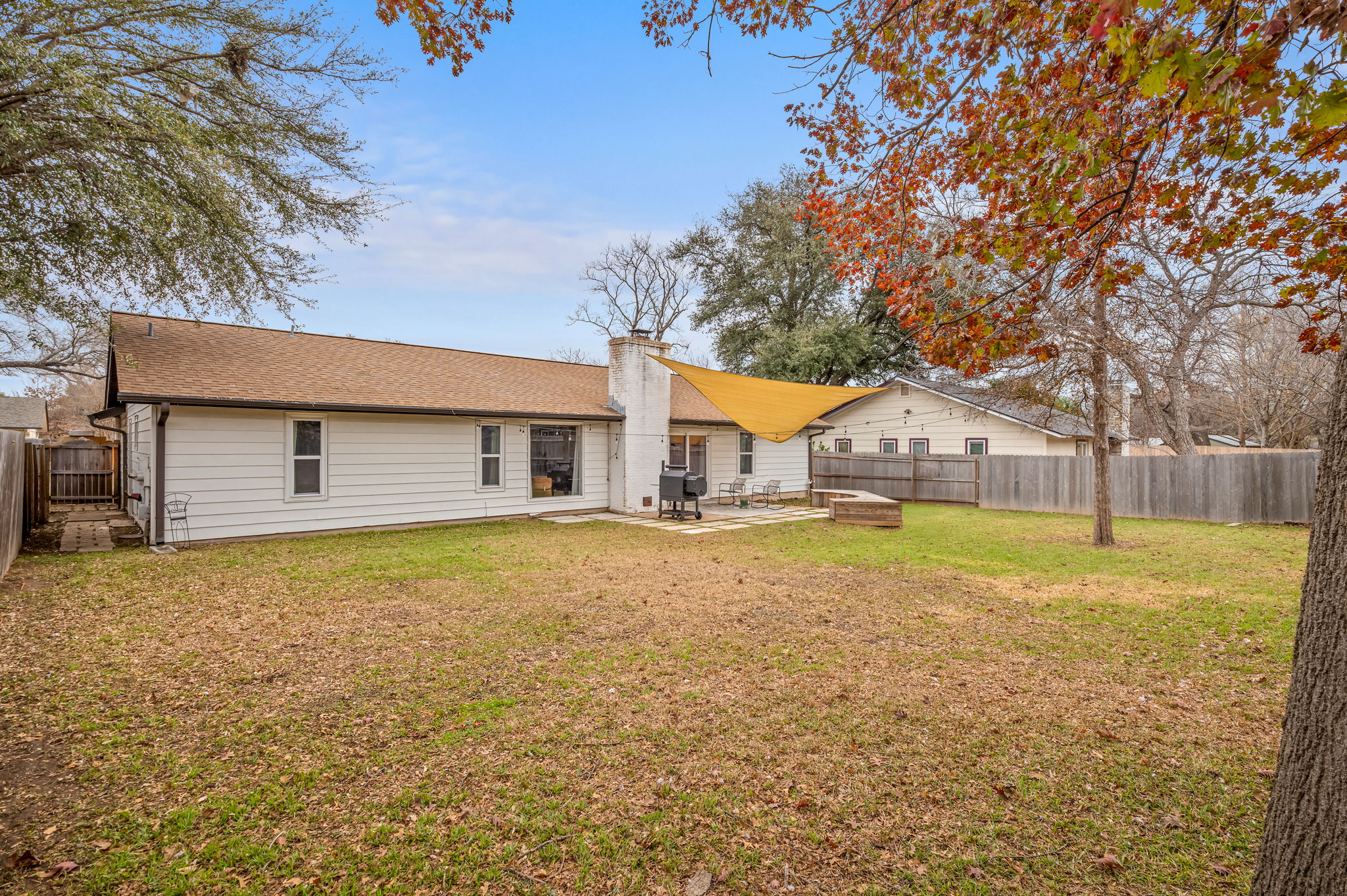 9300 Meadow Vale Austin, TX 78758 - Photo 35 of 37 Back of house with a patio area, a fenced backyard, a chimney, and an outdoor fire pit