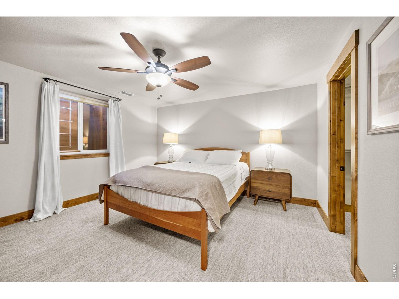 621 Wood Street Fort Collins, CO 80521 - Photo 33 of 50 a bedroom with a bed chandelier and a window