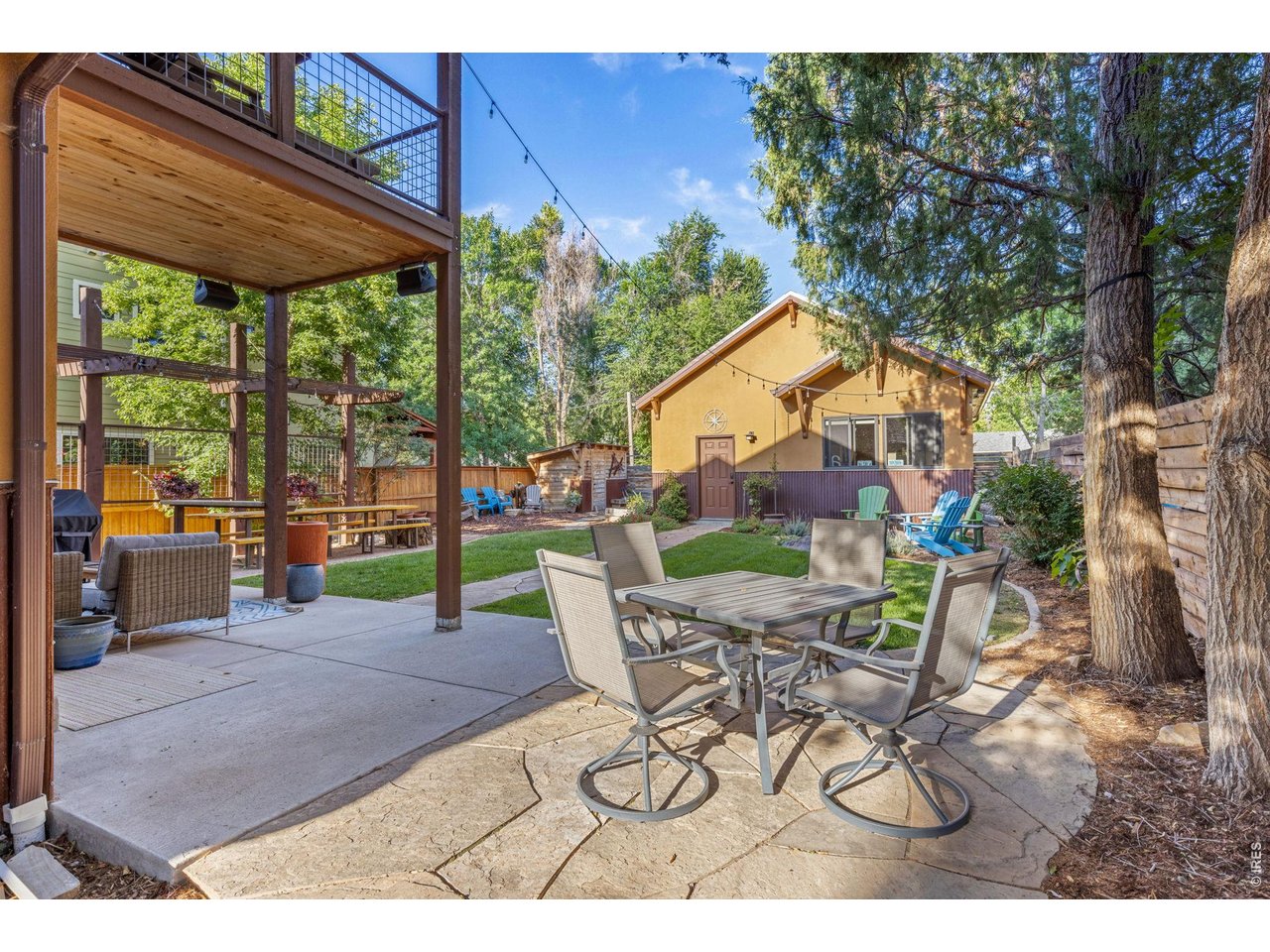 621 Wood Street Fort Collins, CO 80521 - Photo 38 of 50 a view of a patio with a table and chairs under an umbrella