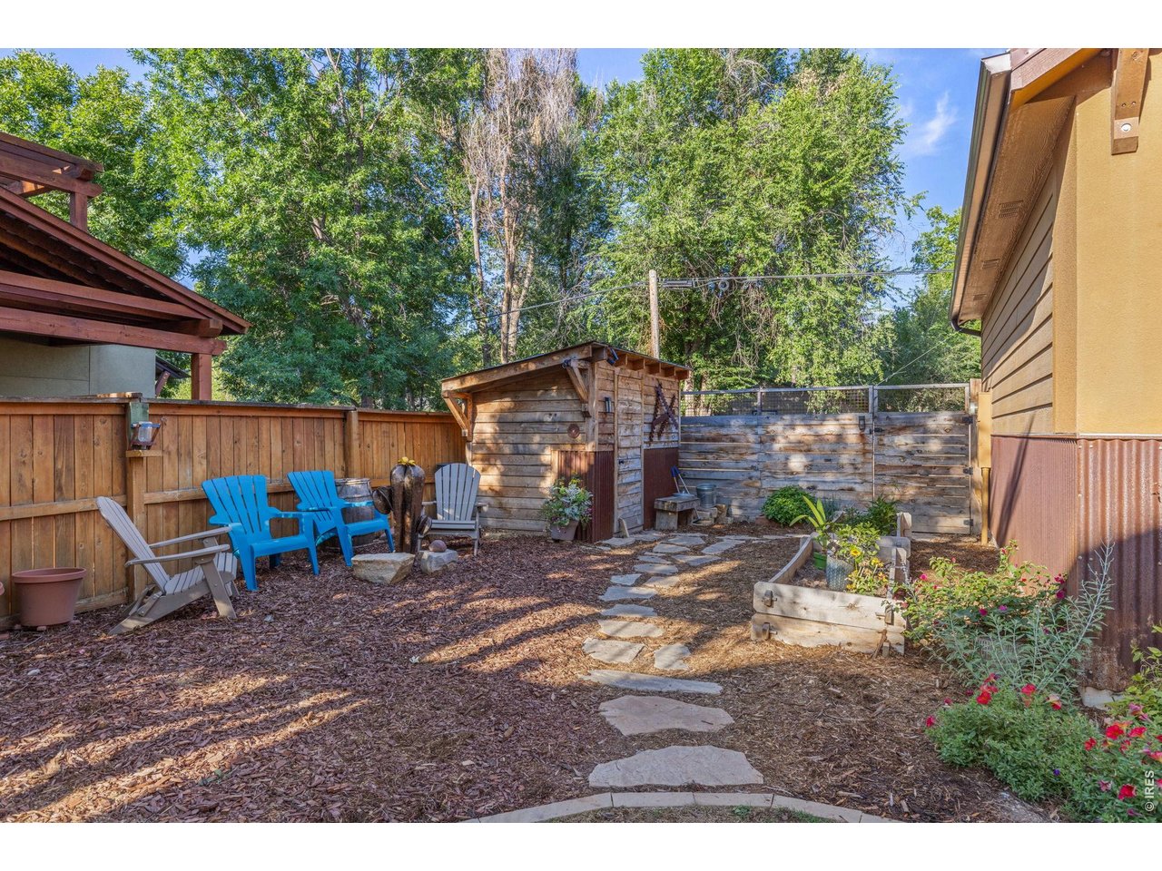 621 Wood Street Fort Collins, CO 80521 - Photo 43 of 50 a view of a wooden chairs and bench in a backyard