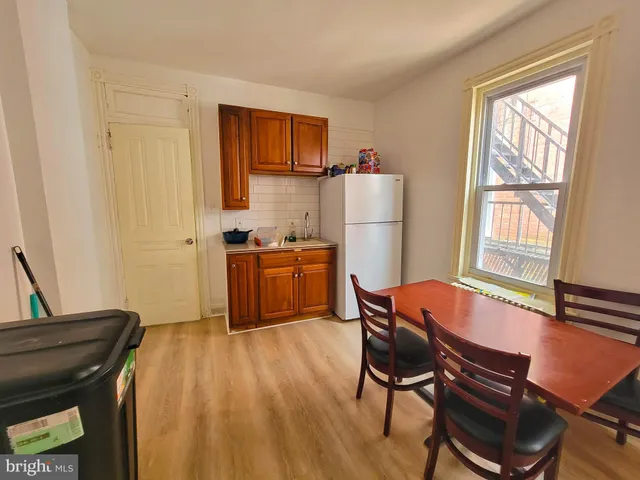 a living room with a bed furniture and a window
