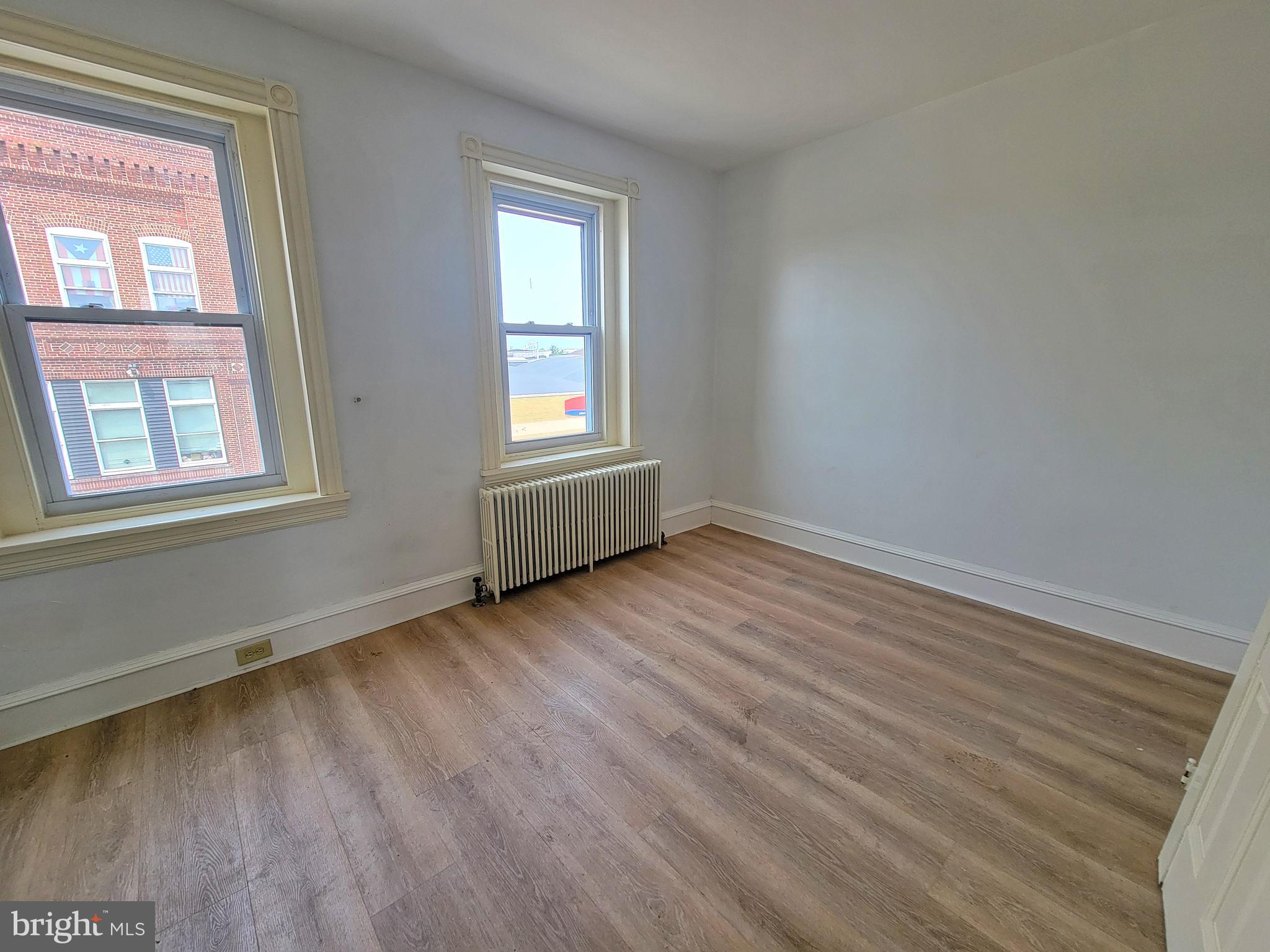 21 South 3rd Street Reading, PA 19602 - Photo 19 of 20 a view of an empty room with wooden floor and a window