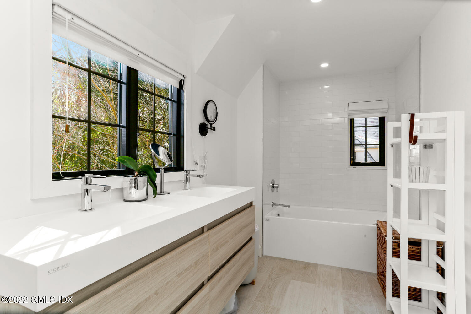 84 Meadow Road Riverside, CT 06878 - Photo 19 of 35 a bathroom with a double vanity sink a mirror and a bathtub