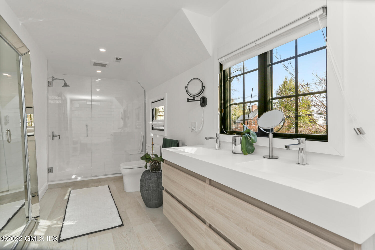 84 Meadow Road Riverside, CT 06878 - Photo 20 of 35 a bathroom with a double vanity sink a mirror and a shower