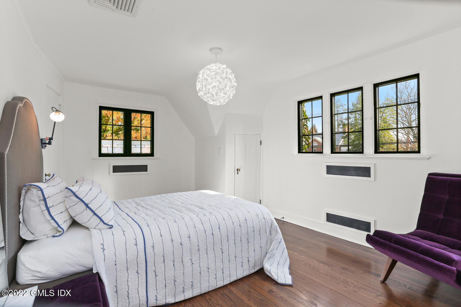 84 Meadow Road Riverside, CT 06878 - Photo 22 of 35 a bedroom with a bed and wooden floor