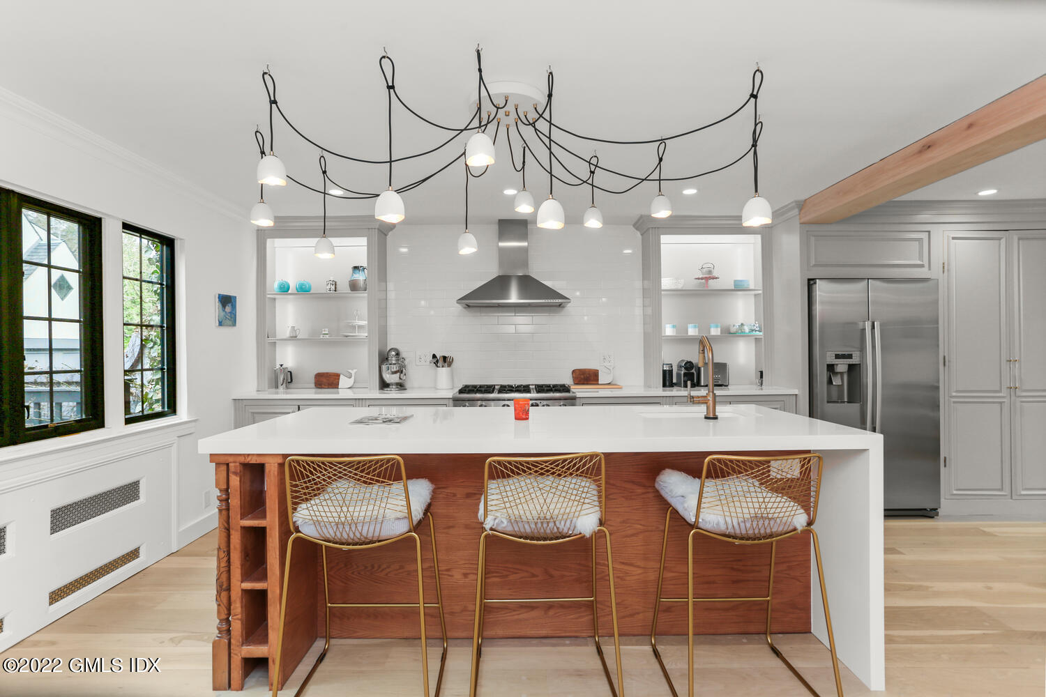 84 Meadow Road Riverside, CT 06878 - Photo 7 of 35 a kitchen with a dining table chairs cabinets and stainless steel appliances