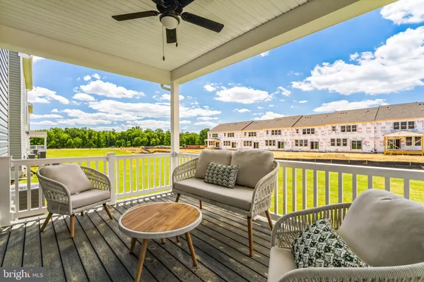 a balcony with furniture and a view of lake