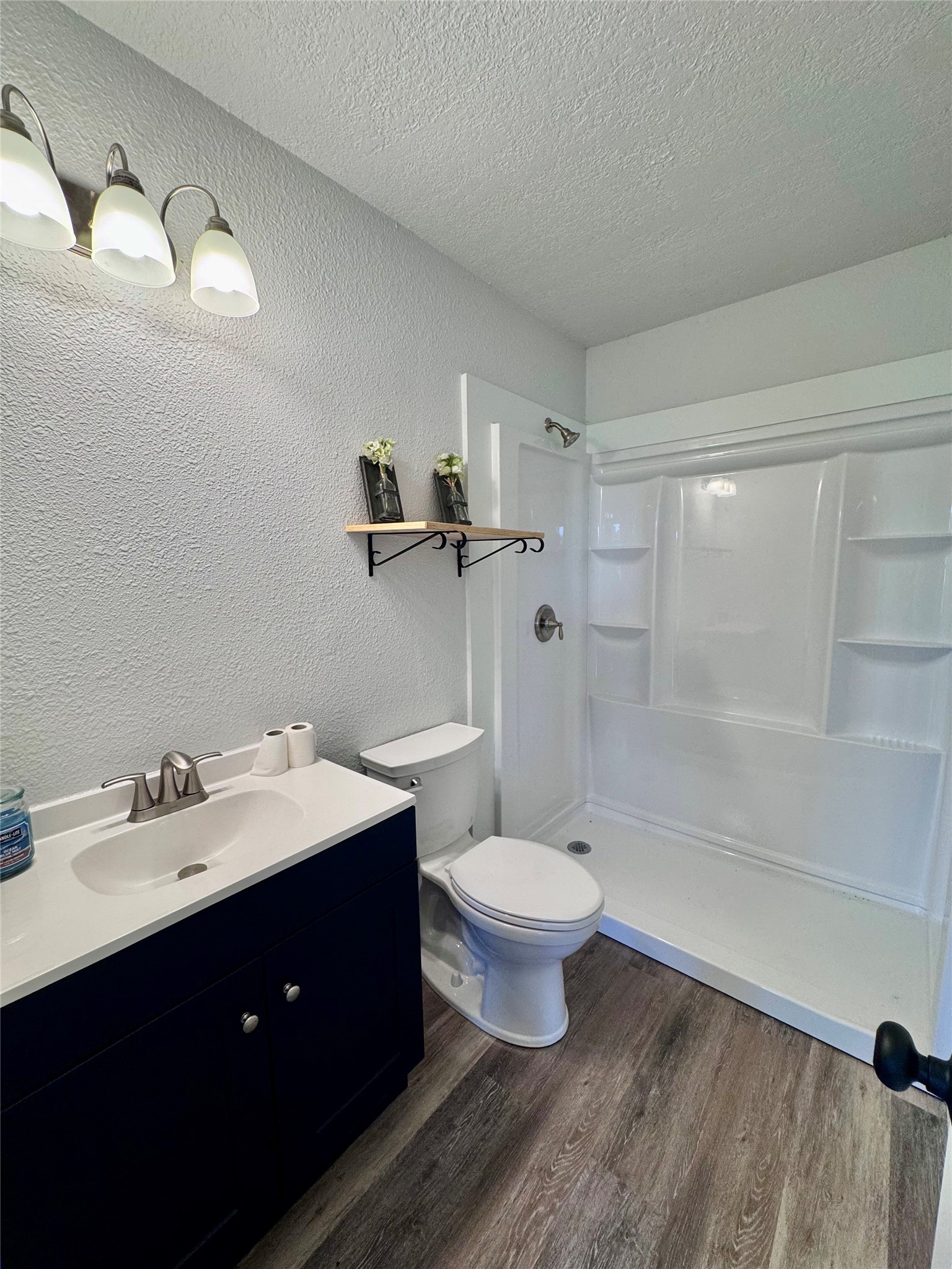 83 Westlake Road Trinity, TX 75862 - Photo 27 of 36 a bathroom with a sink toilet a mirror and shower