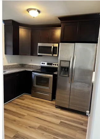 a kitchen with stainless steel appliances a stove and a refrigerator