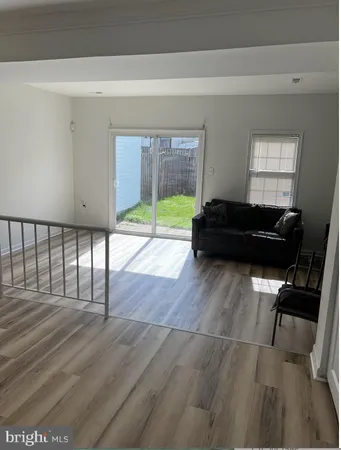 a living room with a bed furniture and a window