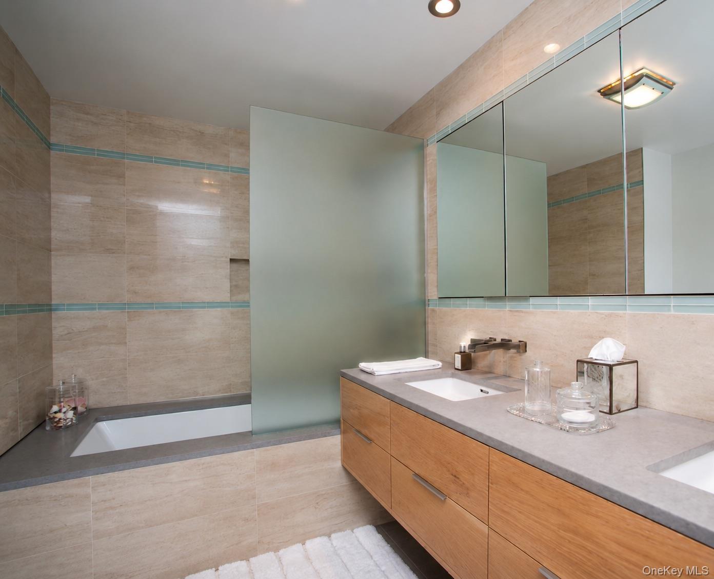 72 Hills Station Road Southampton, NY 11968 - Photo 24 of 33 a bathroom with a sink a light fixture and a glass door shower