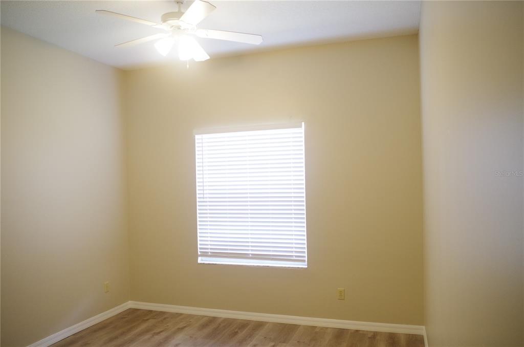 4207 Elba Place Valrico, FL 33596 - Photo 13 of 24 a view of an empty room with chandelier fan and a window