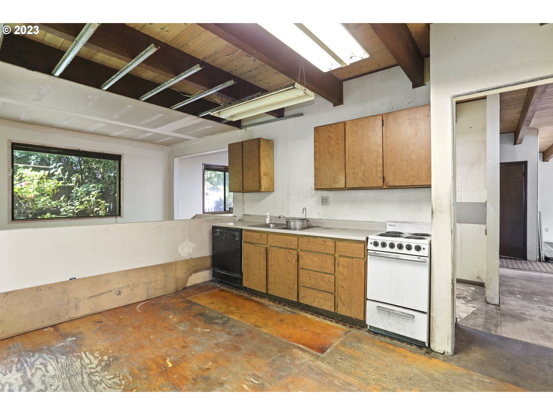 1237 State Street Hood River, OR 97031 - Photo 17 of 42 a kitchen with stainless steel appliances kitchen island granite countertop a stove top oven a sink and a refrigerator