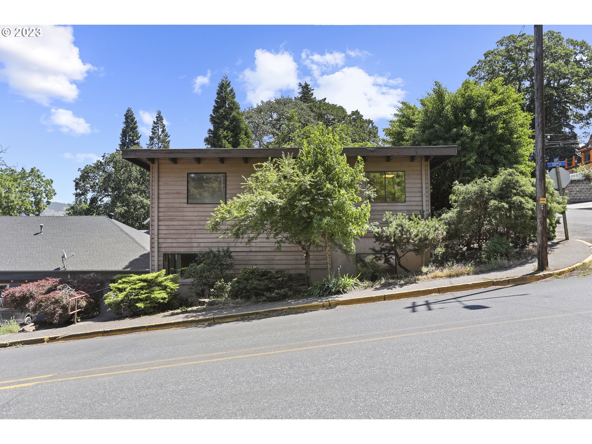 1237 State Street Hood River, OR 97031 - Photo 37 of 42 a potted plant sitting in front of a house