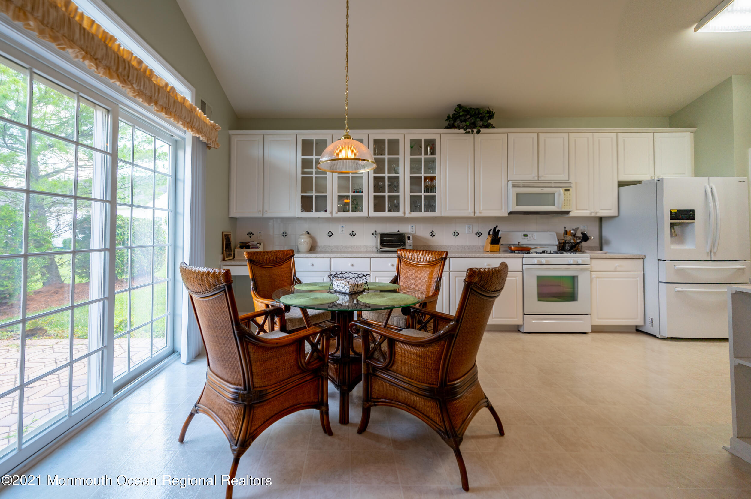4 Chandon Road Manchester Township, NJ 08759 - Photo 16 of 38 a kitchen with stainless steel appliances a table chairs and a refrigerator