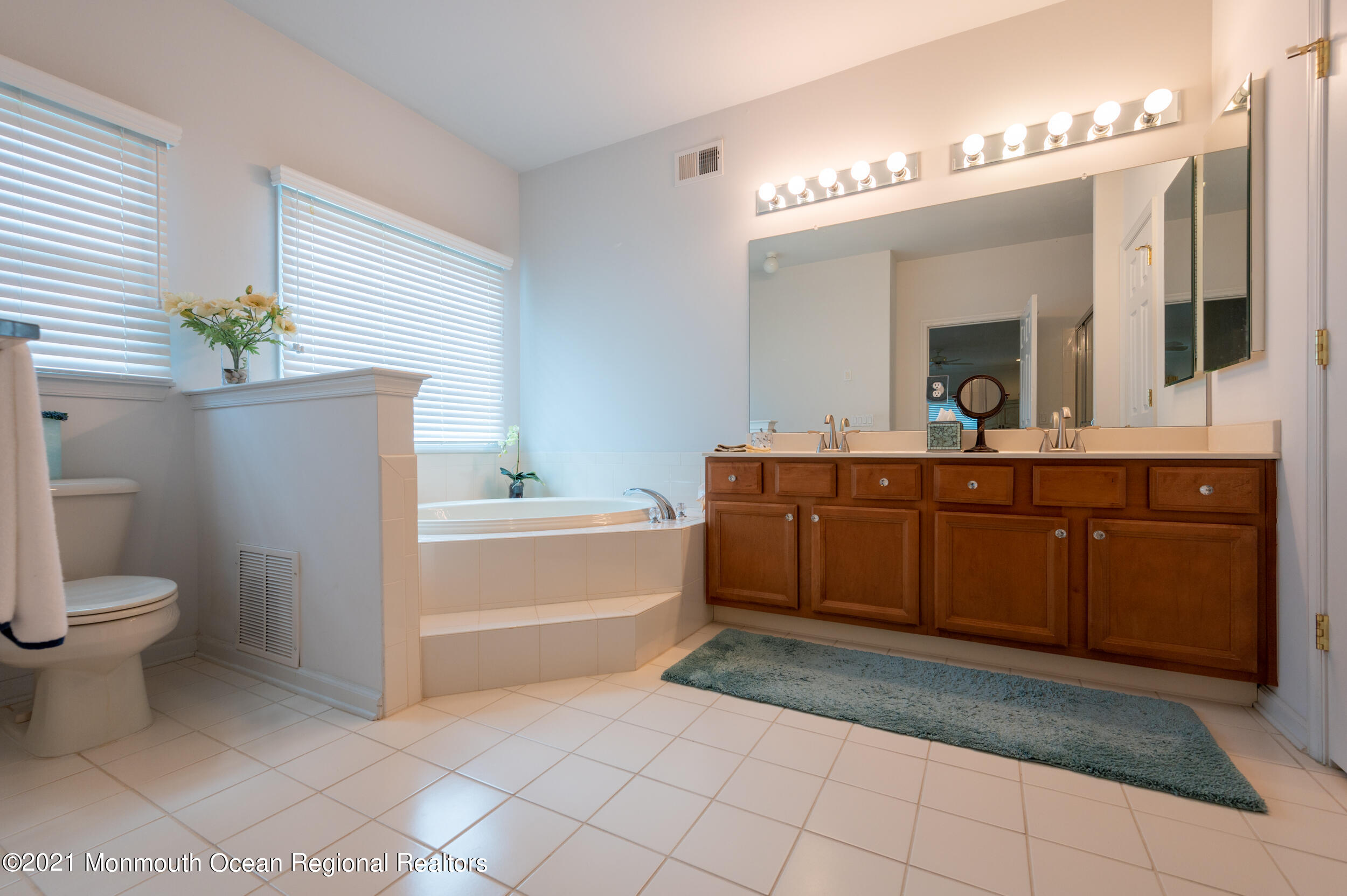 4 Chandon Road Manchester Township, NJ 08759 - Photo 23 of 38 a bathroom with a sink a toilet and mirror