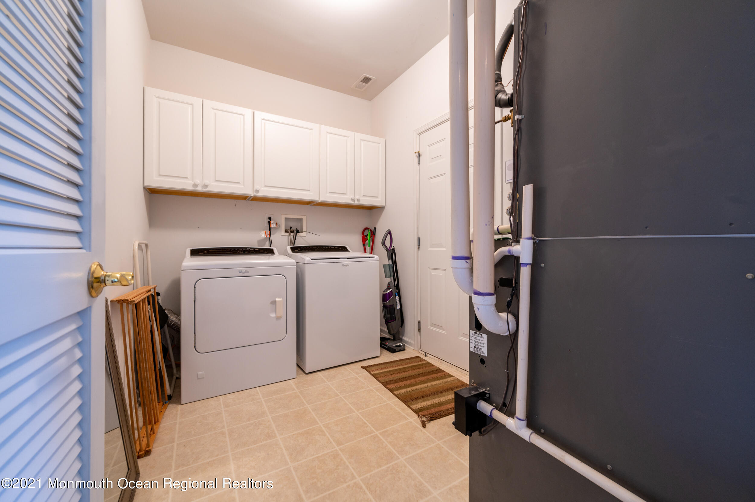 4 Chandon Road Manchester Township, NJ 08759 - Photo 28 of 38 a view of a storage and utility room with washer and dryer