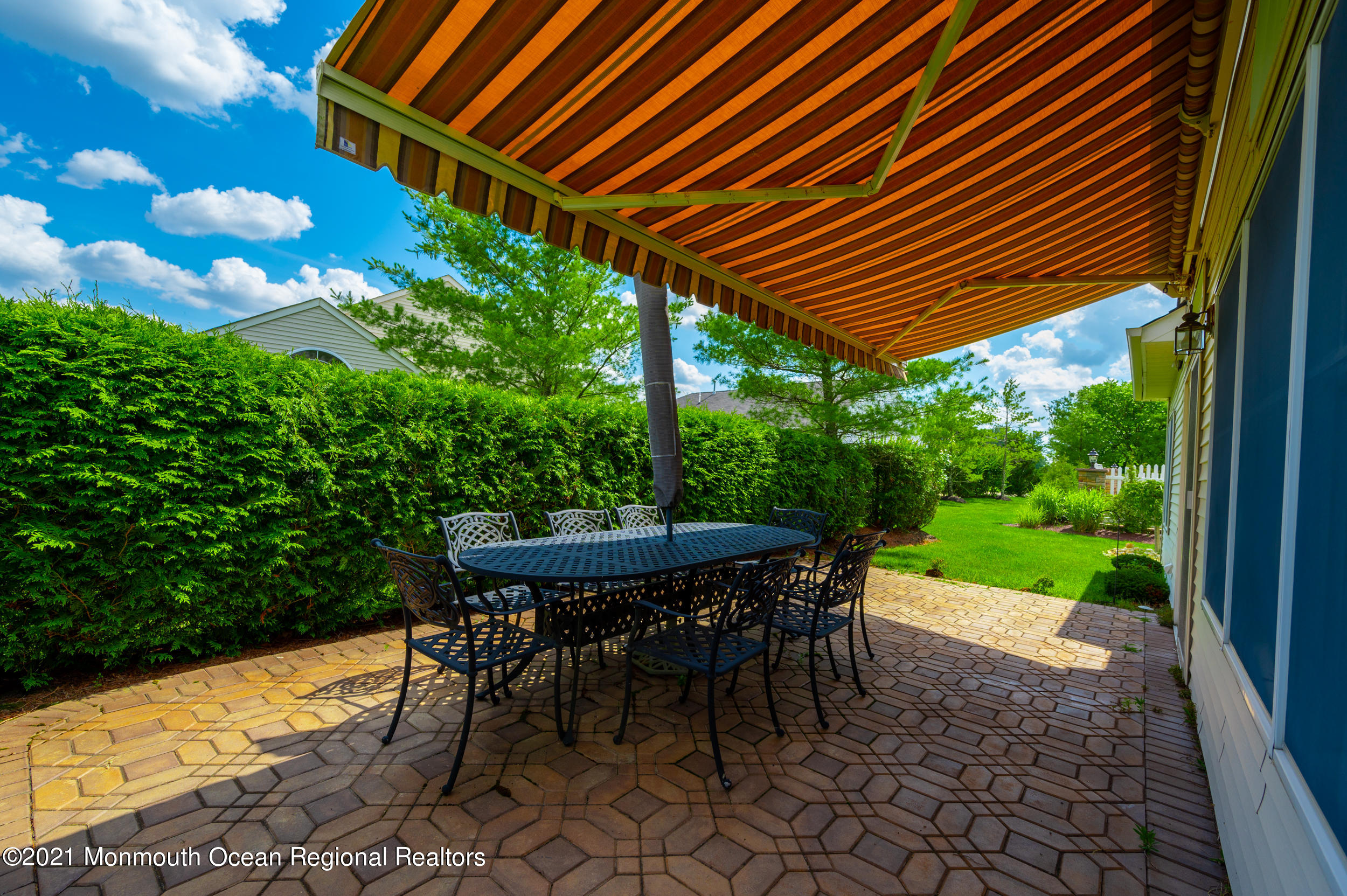 4 Chandon Road Manchester Township, NJ 08759 - Photo 29 of 38 a view of a patio with table and chairs under an umbrella