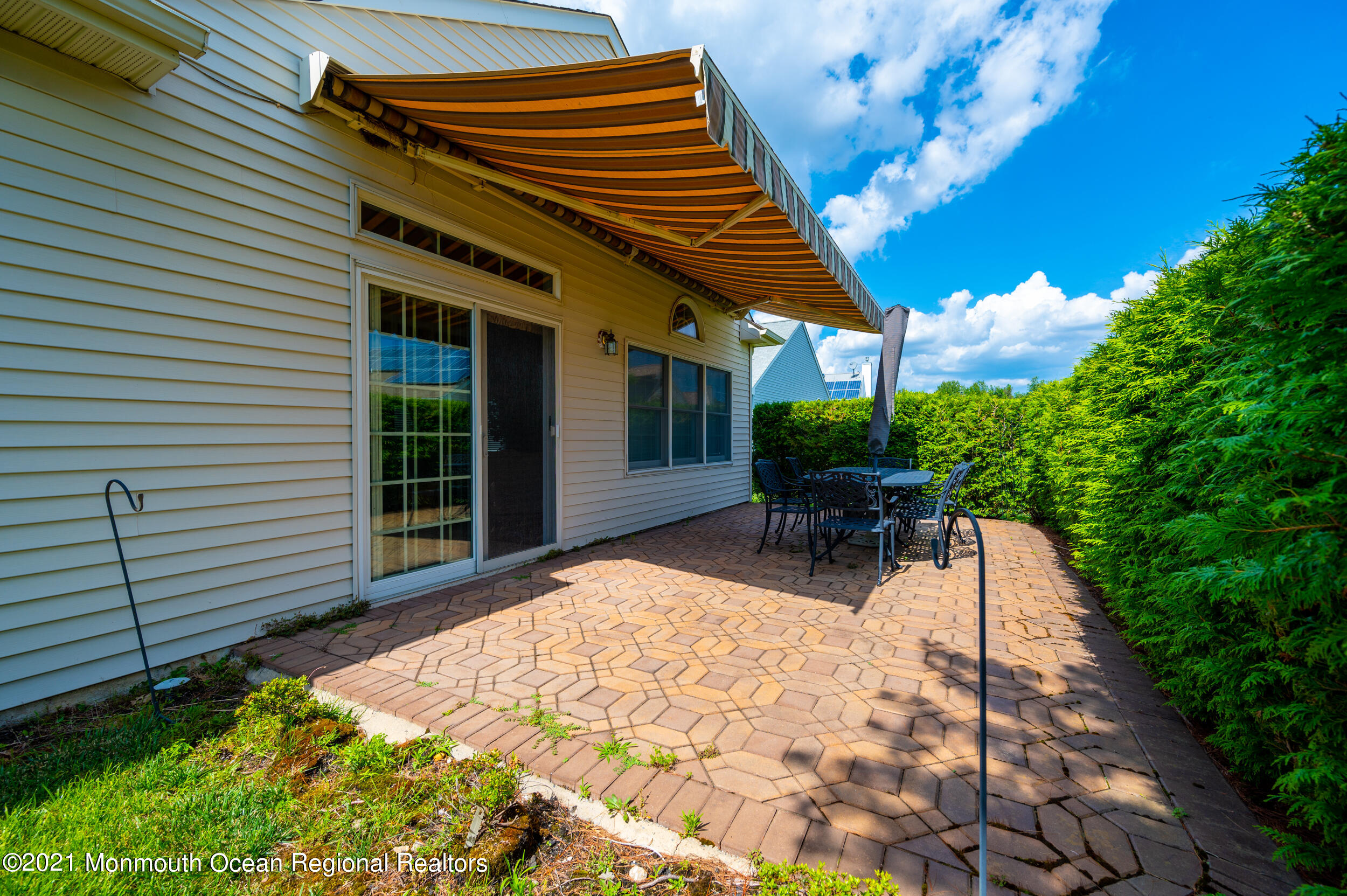 4 Chandon Road Manchester Township, NJ 08759 - Photo 30 of 38 a view of a patio with a table and chairs and potted plants