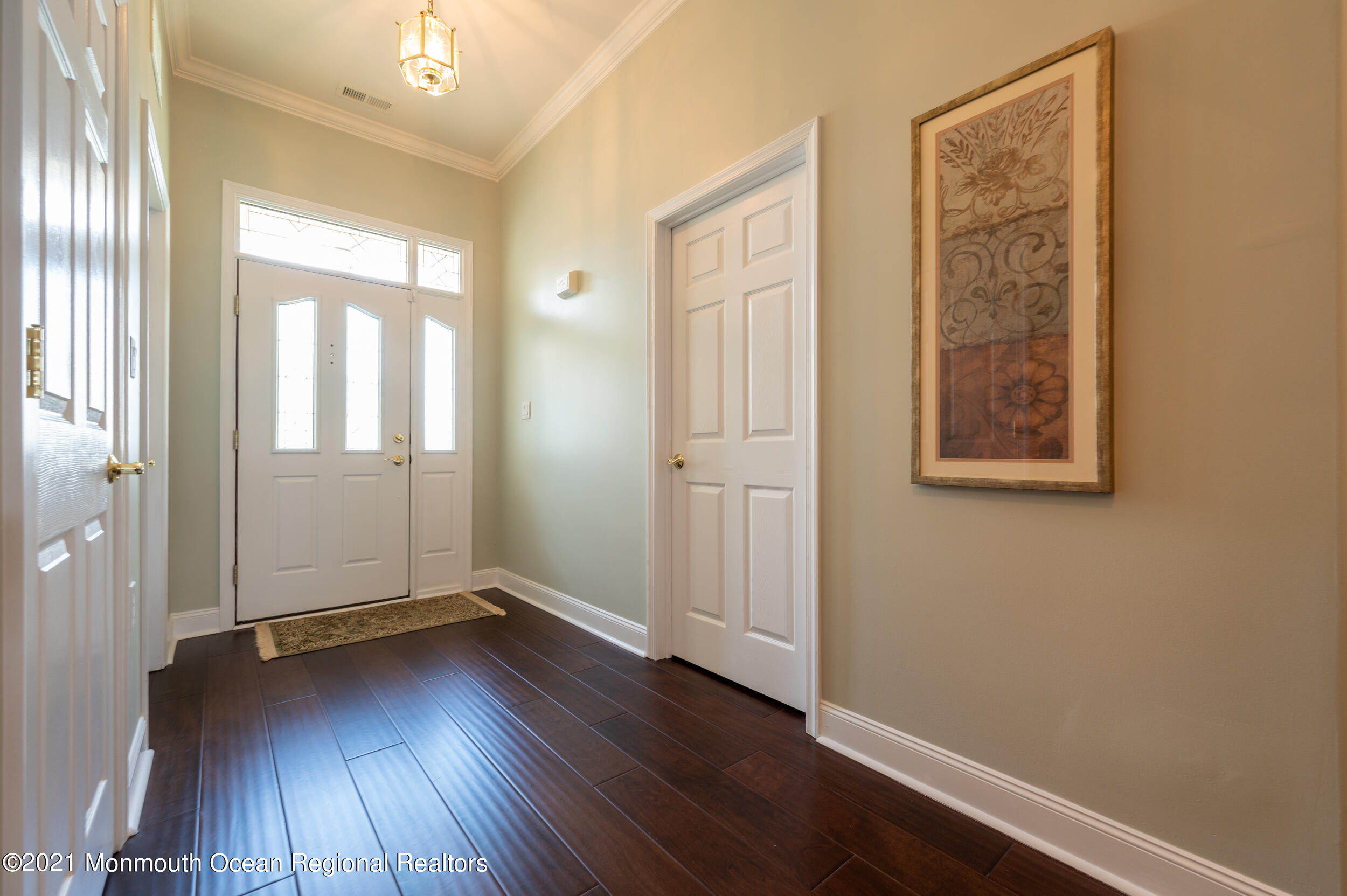 4 Chandon Road Manchester Township, NJ 08759 - Photo 4 of 38 an empty room with wooden floor and windows