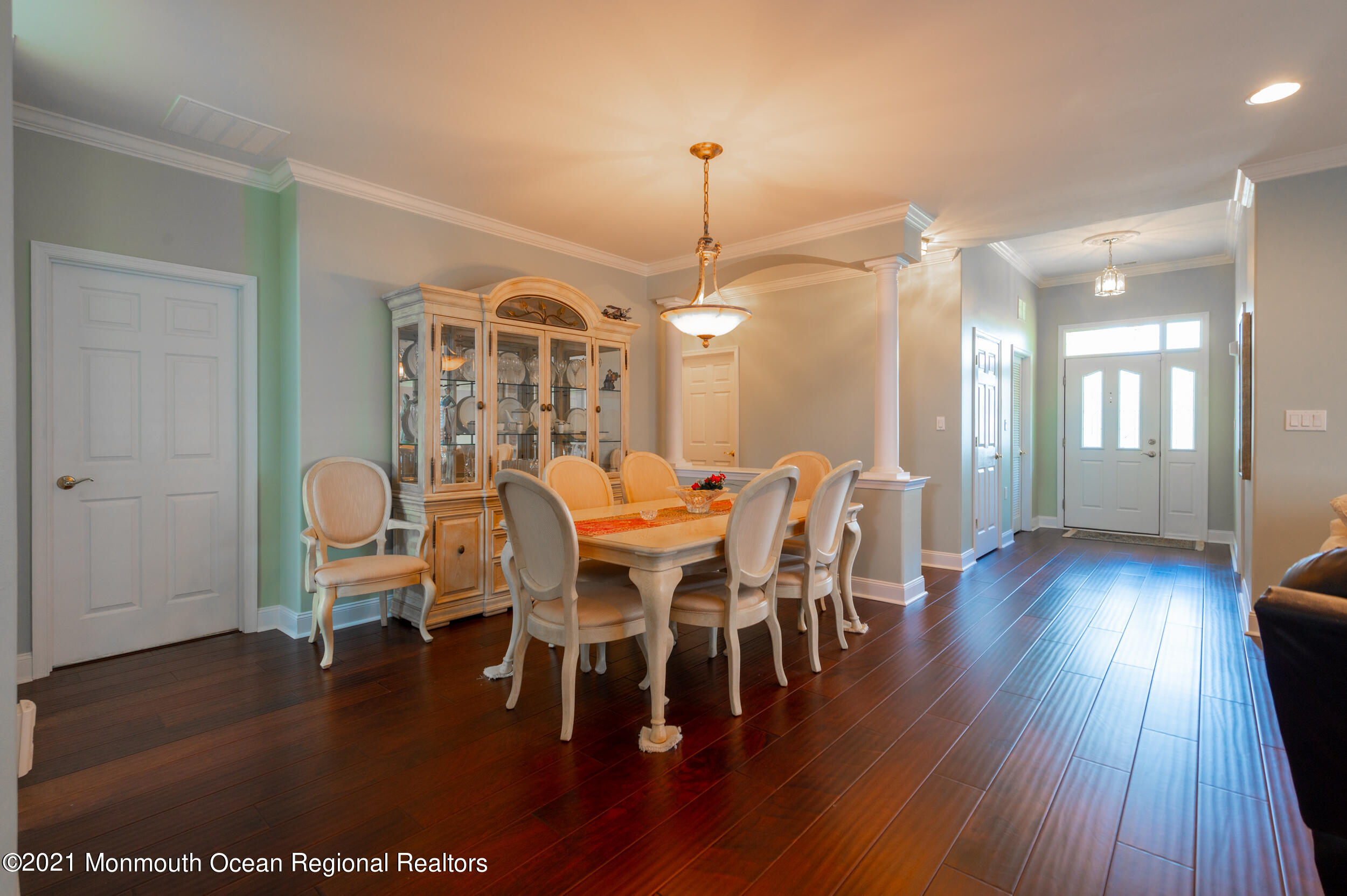 4 Chandon Road Manchester Township, NJ 08759 - Photo 9 of 38 a dining room with wooden floor a chandelier a wooden table and chairs