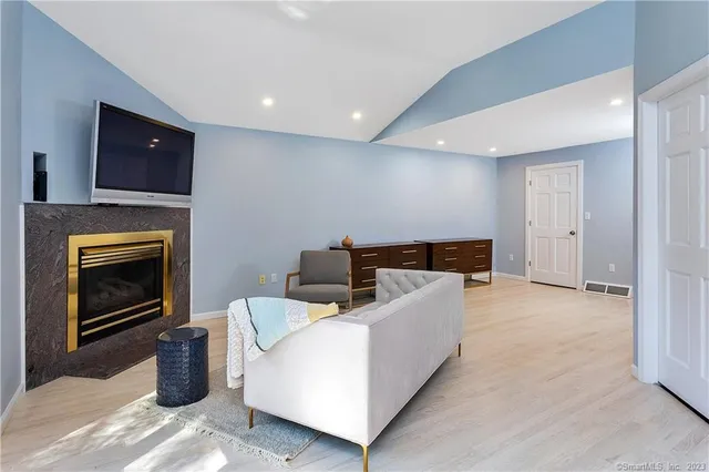 a living room with furniture and a fireplace