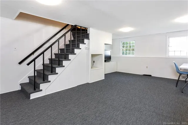 a view of entryway with stairs and wooden floor