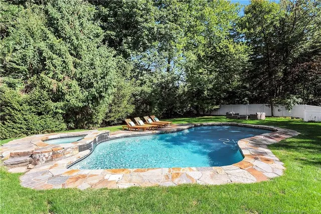 a view of a swimming pool with a yard