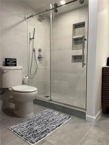 a bathroom with a toilet and a shower