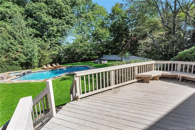 a balcony with wooden floor and outdoor space