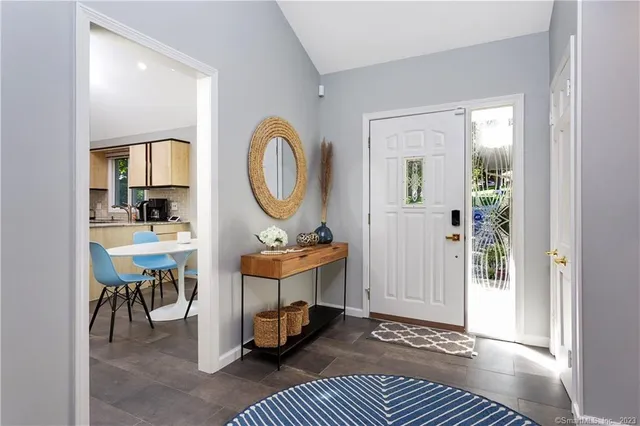 a view of a livingroom with furniture and a window