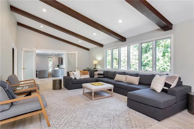 a living room with furniture and large windows