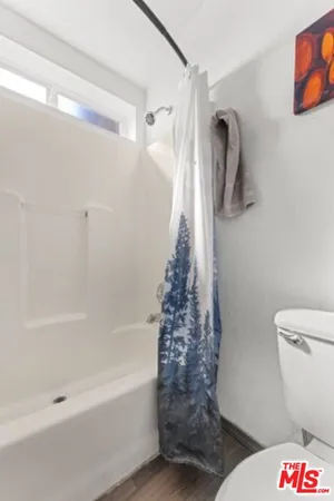 a bathroom with a toilet and a shower