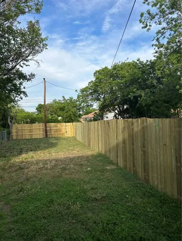 a view of a garden with a building in the background