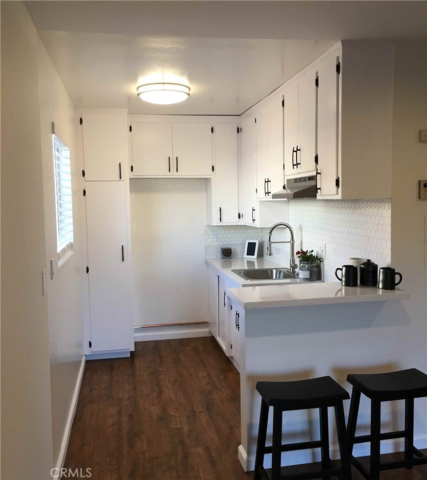 14718 West Magnolia Boulevard, Unit 3 Sherman Oaks, CA 91403 - Photo 2 of 5 a kitchen with granite countertop a sink cabinets and refrigerator