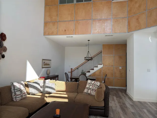 a living room with furniture and stairs