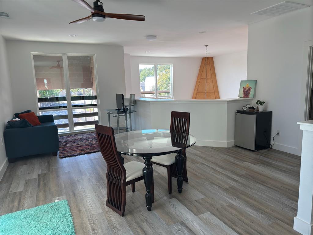 9497 Timberleaf Drive Dallas, TX 75243 - Photo 4 of 10 a view of a dining room with furniture and wooden floor