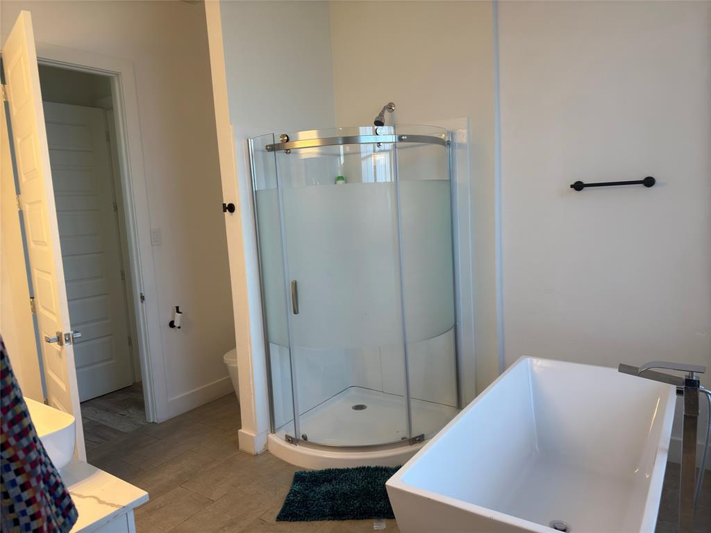 9497 Timberleaf Drive Dallas, TX 75243 - Photo 7 of 10 a bathroom with a bathtub and a shower