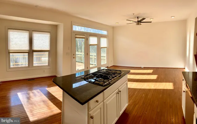a kitchen with granite countertop a stove and a window